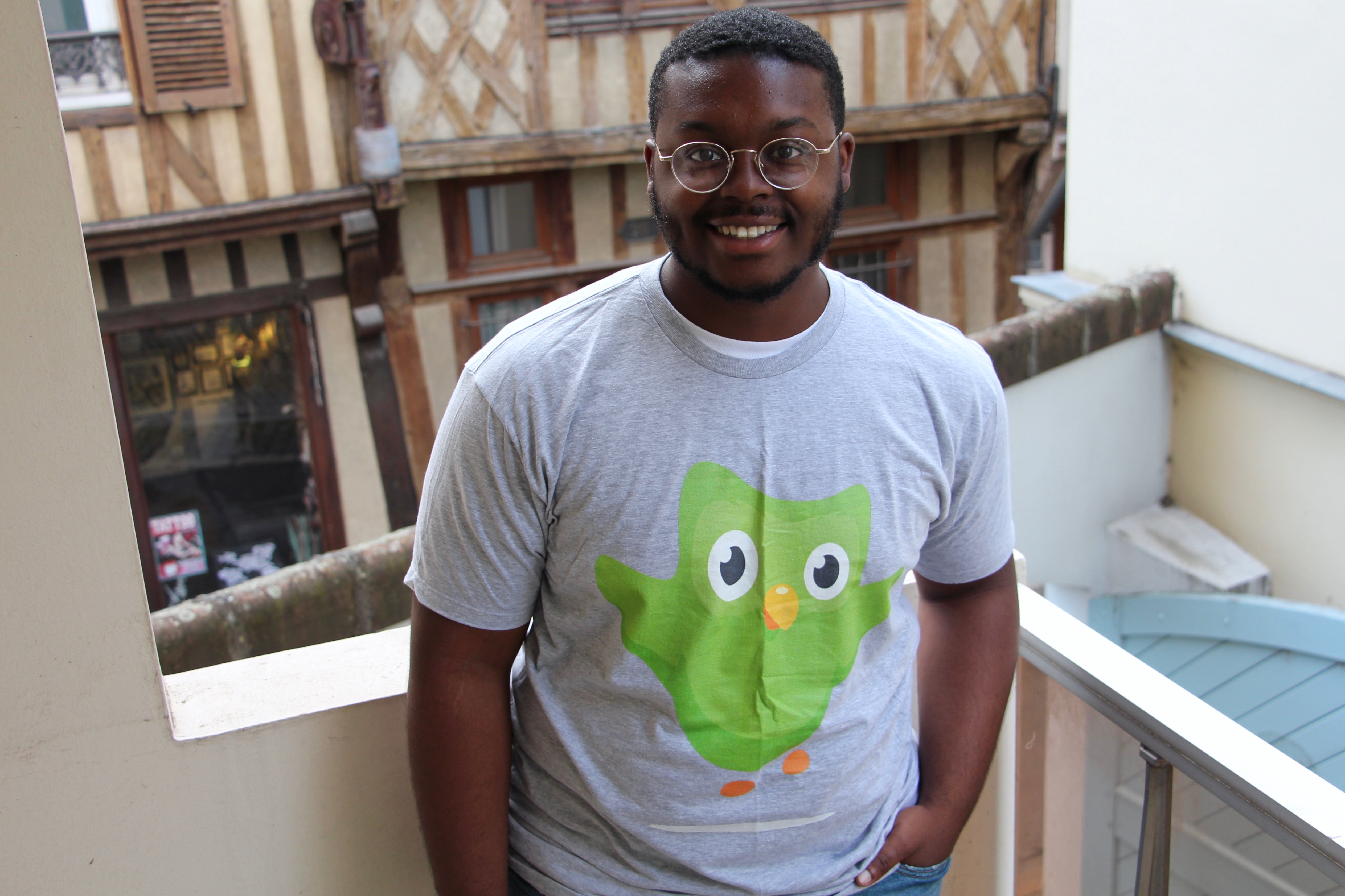 Jalen wearing a Duolingo shirt in France.