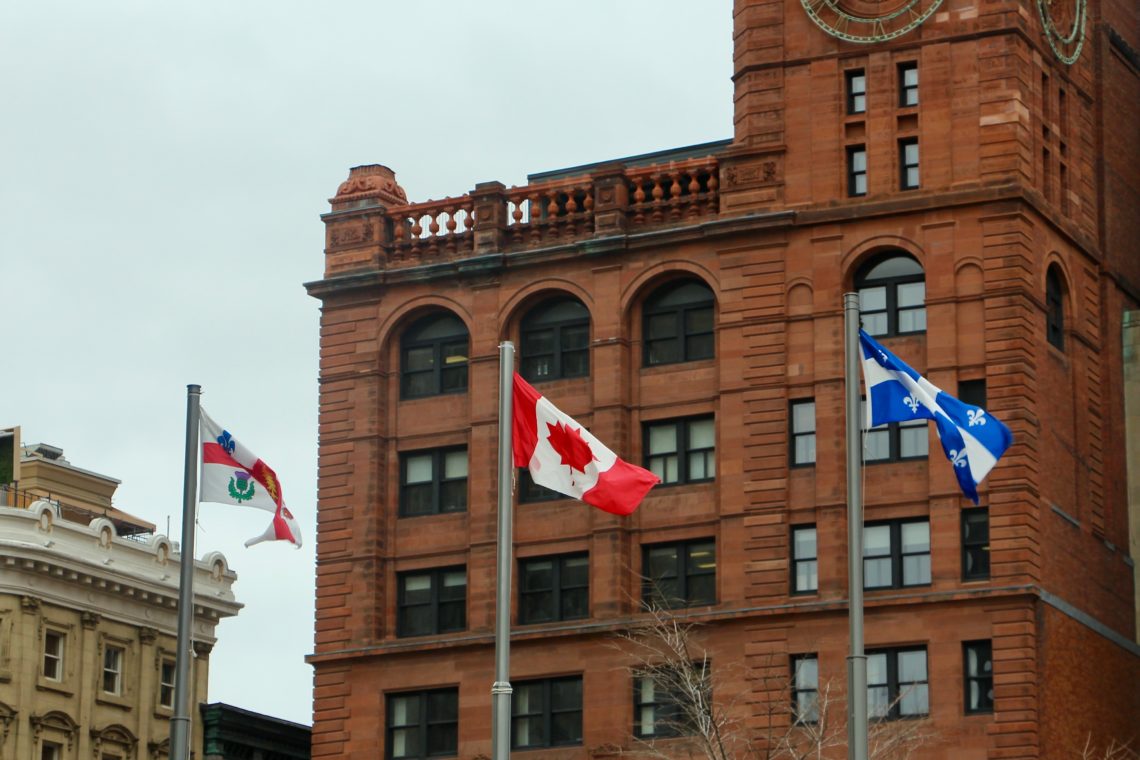 Montréal, Canada, and Québec flags flying.