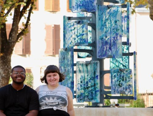 Jalen and Maria in front of a sculpture in Troyes.