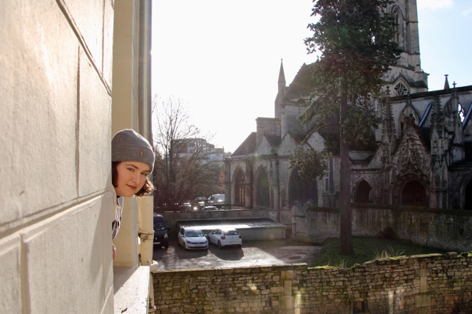 Maria looking out of the window of our Airbnb.