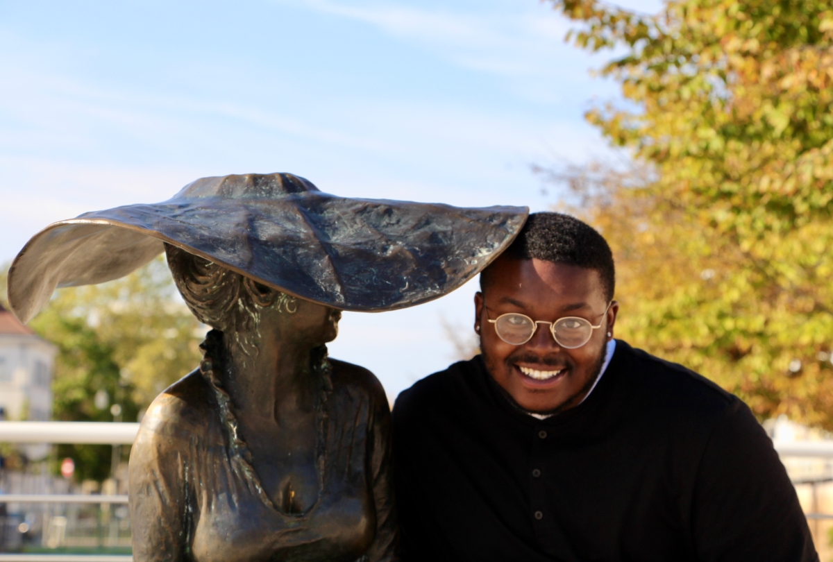 Jalen sitting with the statue of Lili.