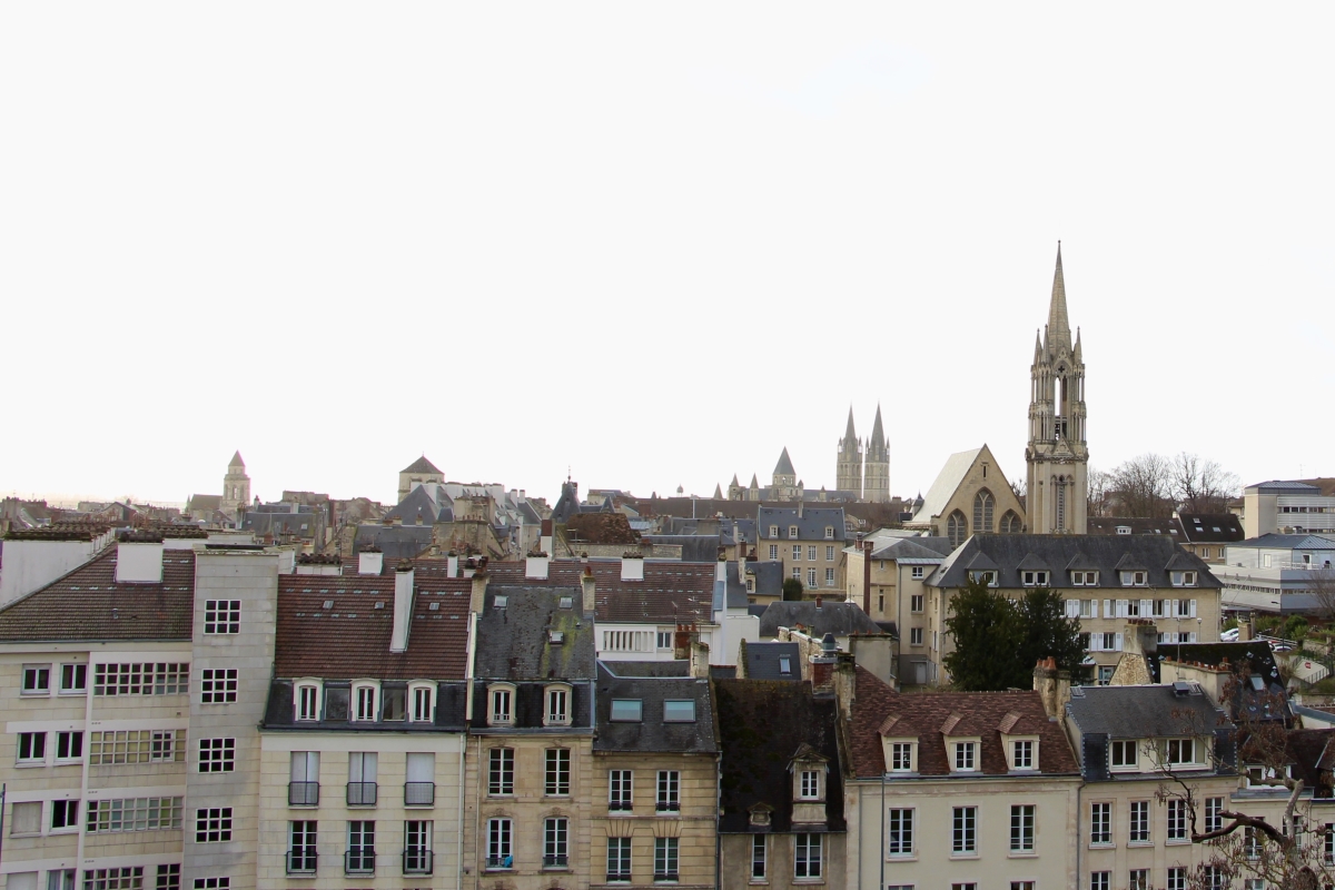 A view of the rooftops on a cloudy day in Caen.