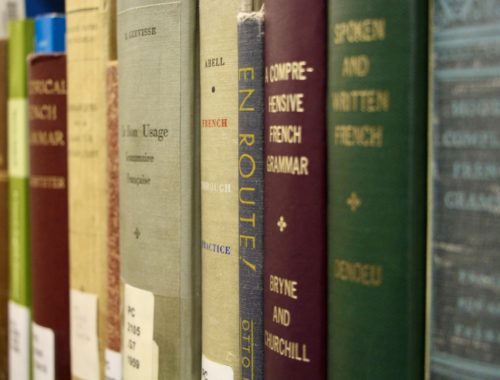 A row of French library books on a shelf.