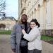Jalen and Maria posing in front of a white building in Caen.