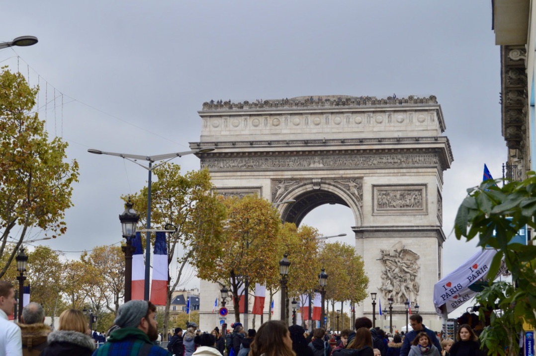 A view of the Arc de Triomphe from a crowded Champs-Elysées.