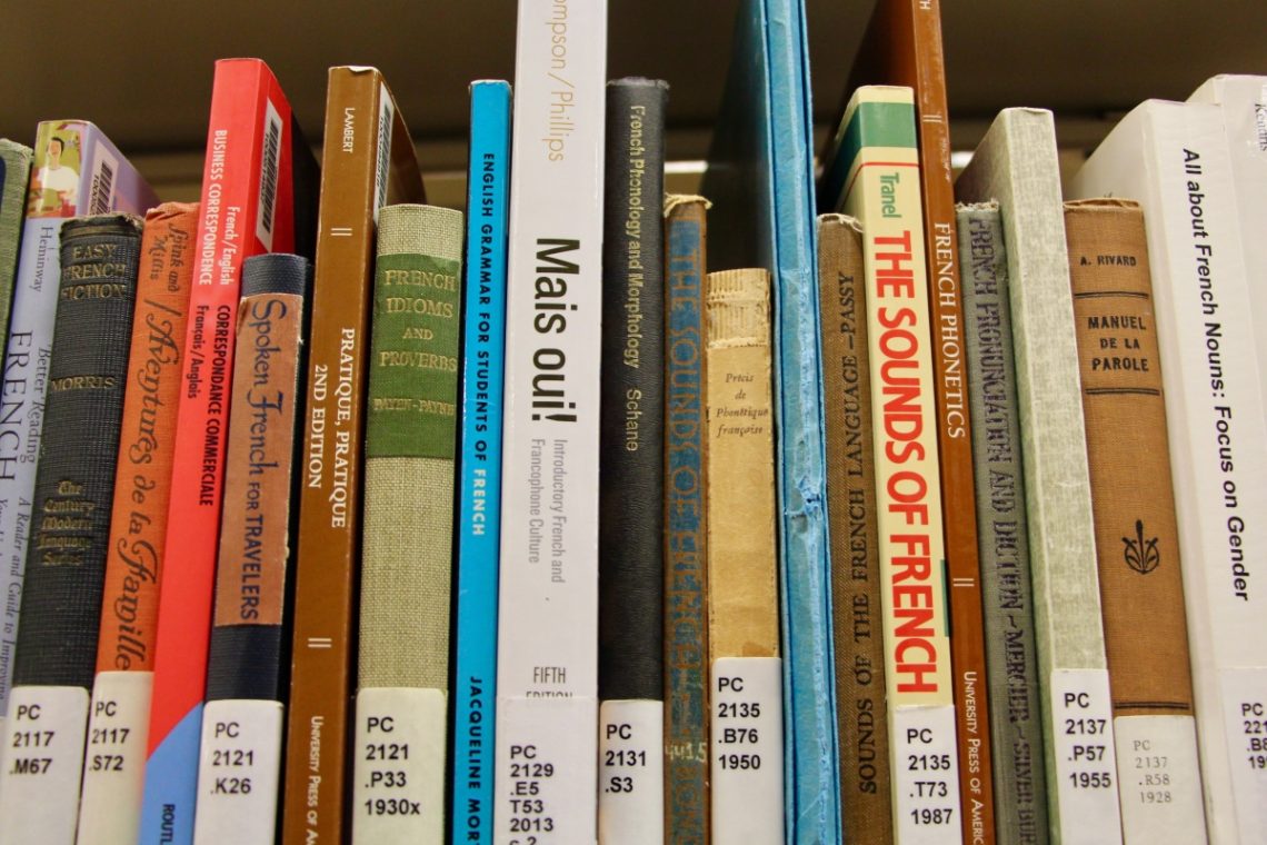 A row of books about learning French in a library.