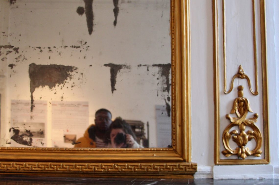 Jalen and Maria, blurred in a selfie in an antique mirror.
