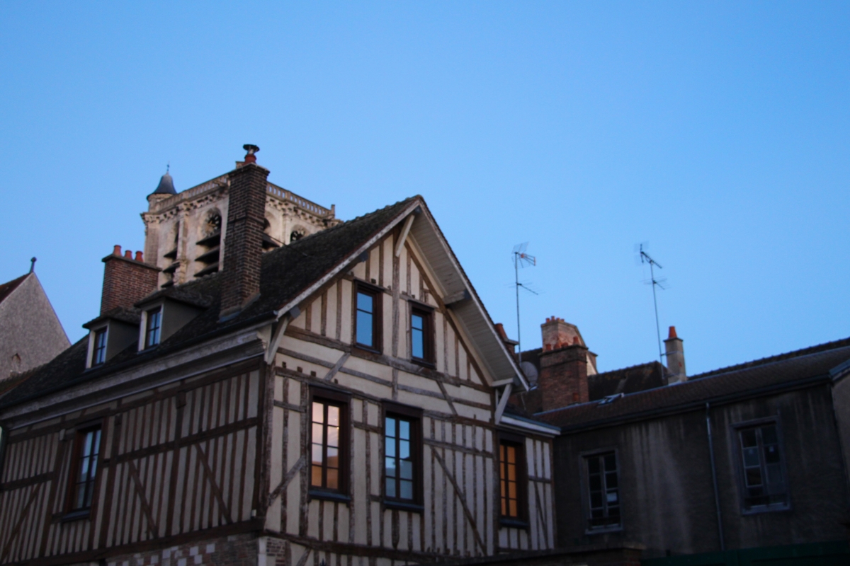 A timber-framed Troyen house at dusk.