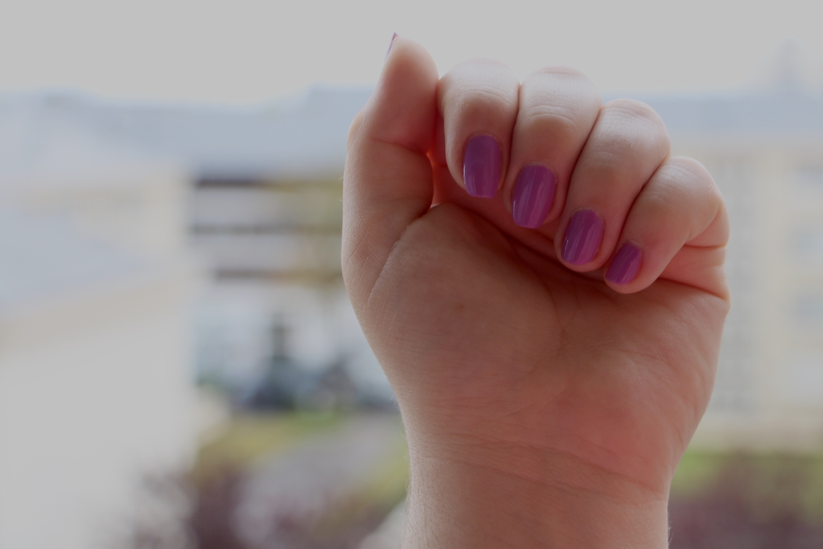 Maria's fingernails painted with purple polish.