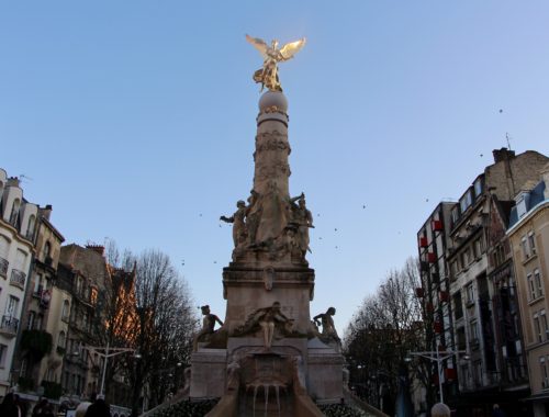La Fontaine Subé in Reims, France against a blue sky.