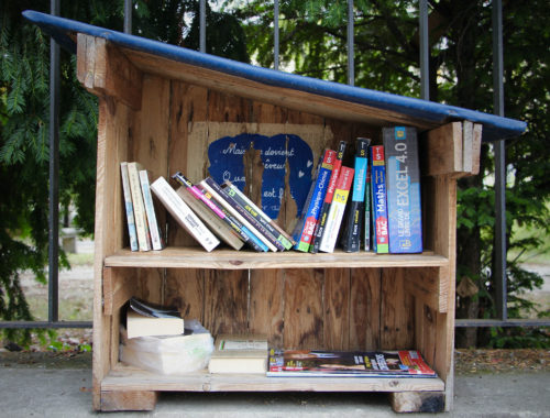 Small, free library filled with colorful books.