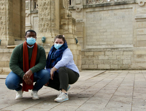 Jalen and Maria posed squatting in front of a fountain in Reims, France.