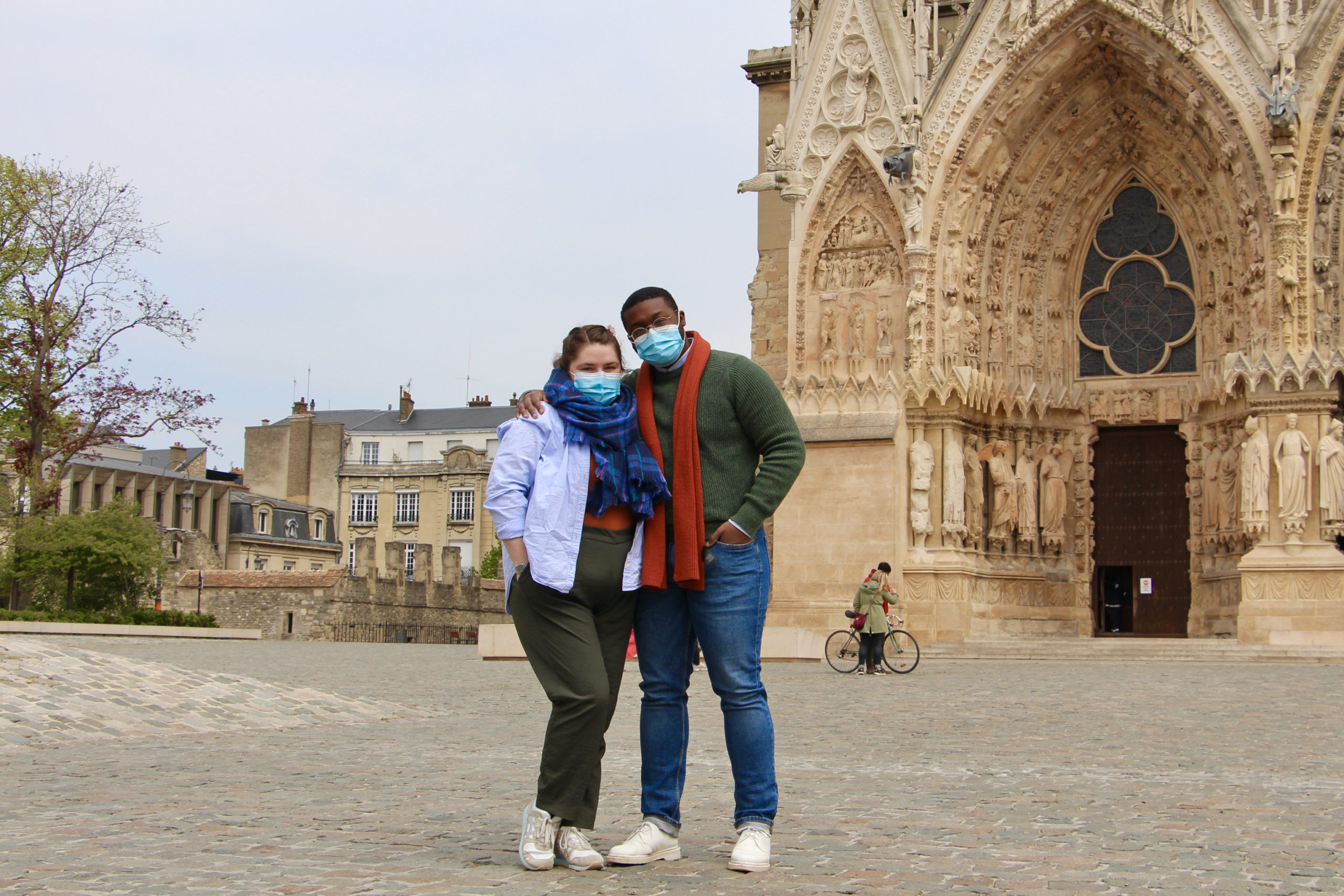 Maria and Jalen stand together in front of the cathedral in Reims, France.