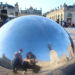 Jalen and Maria pose for a selfie in a reflective hemisphere in Place Stanislas in Nancy, France.
