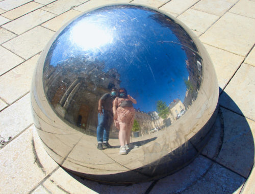 Jalen and Maria pose for a selfie in a reflective hemisphere in Nancy, France.