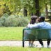 Maria and Jalen kiss on a park bench in Reims, France.