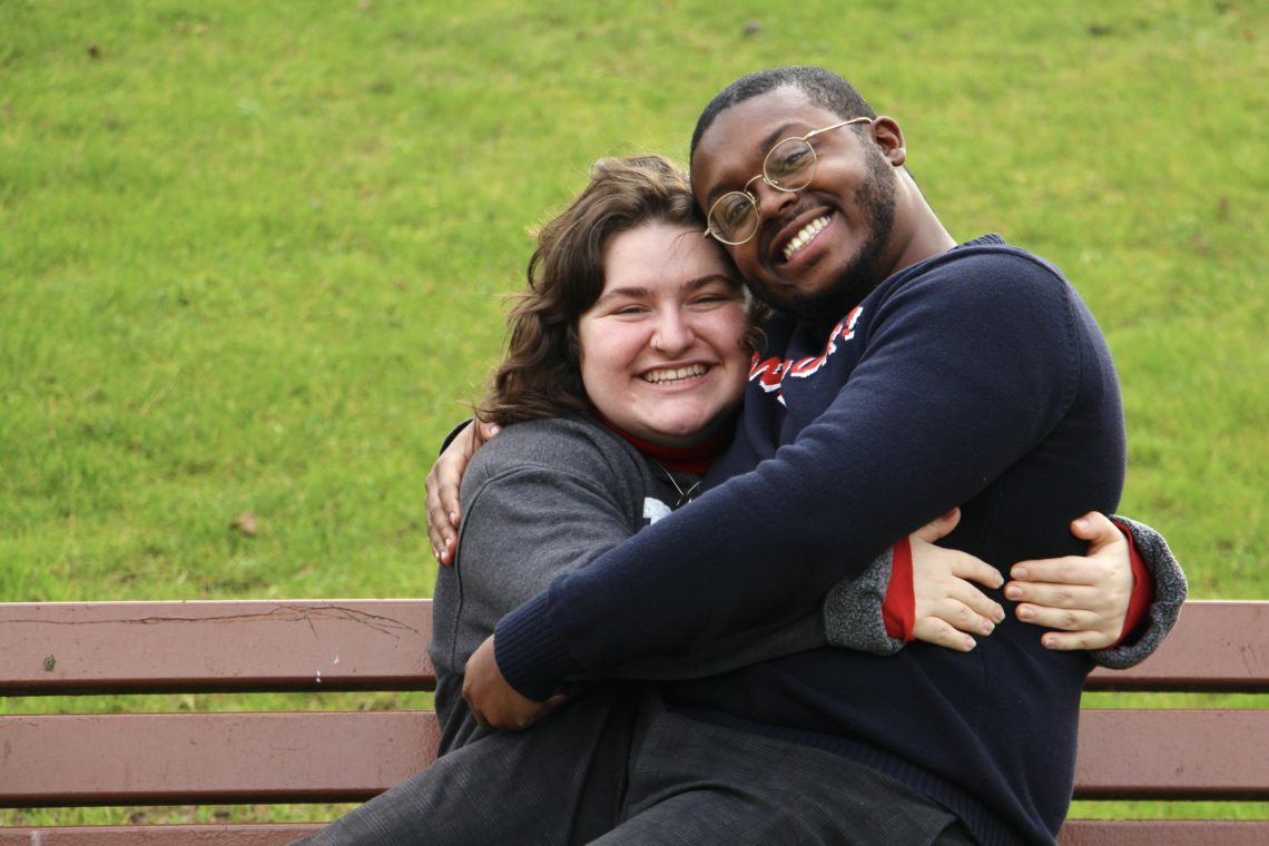Maria and Jalen hugging on a bench in Reims, France.