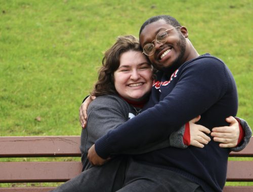 Maria and Jalen hugging on a bench in Reims, France.