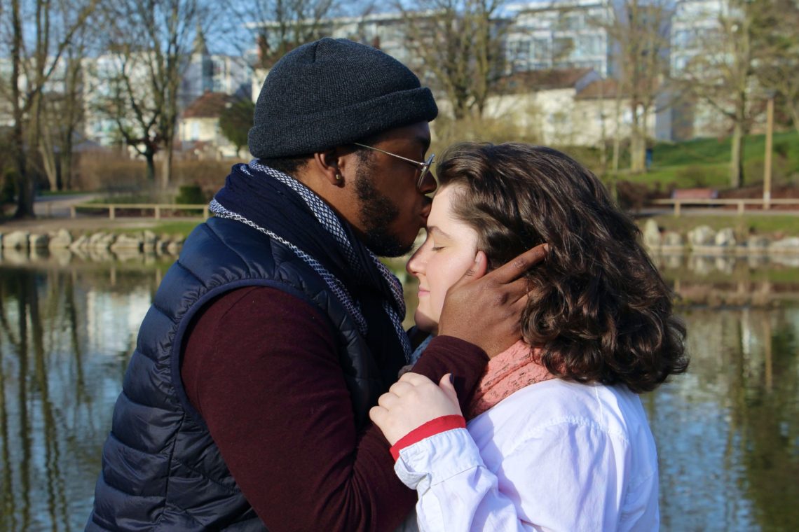 Jalen kisses Maria's forehead at Parc Léo Lagrange in Reims, France.