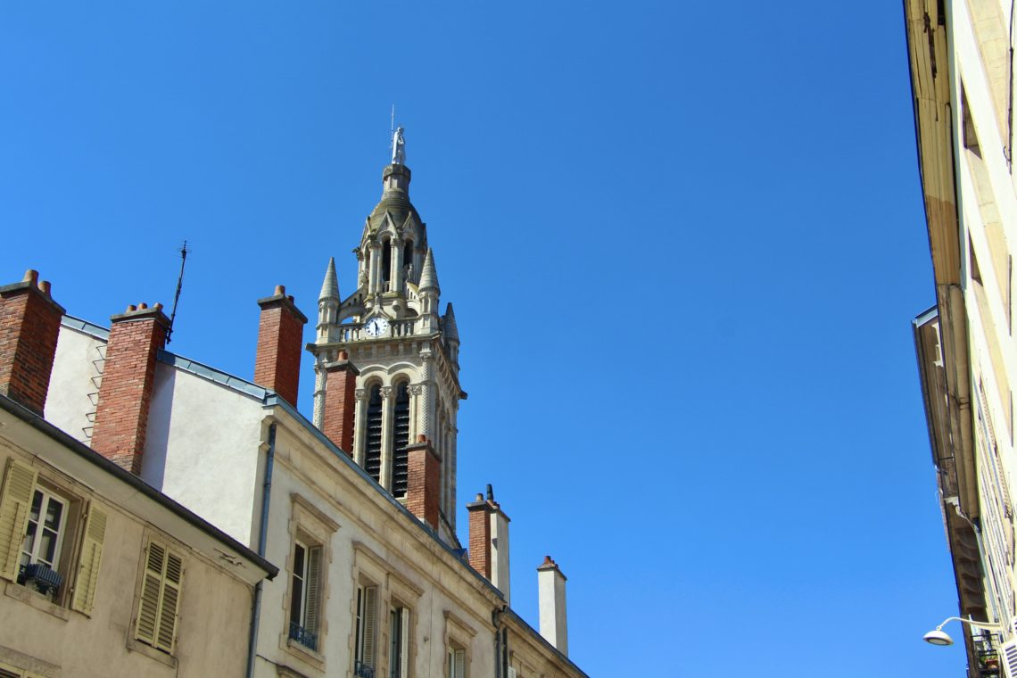 A tower against a blue sky in Nancy, France.