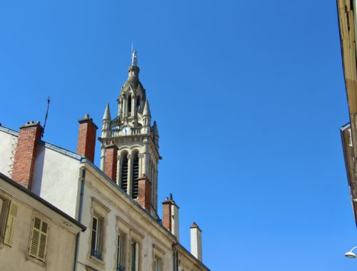 A tower against a blue sky in Nancy, France.
