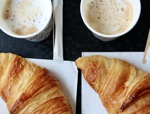 Two croissants and two cappuccinos.