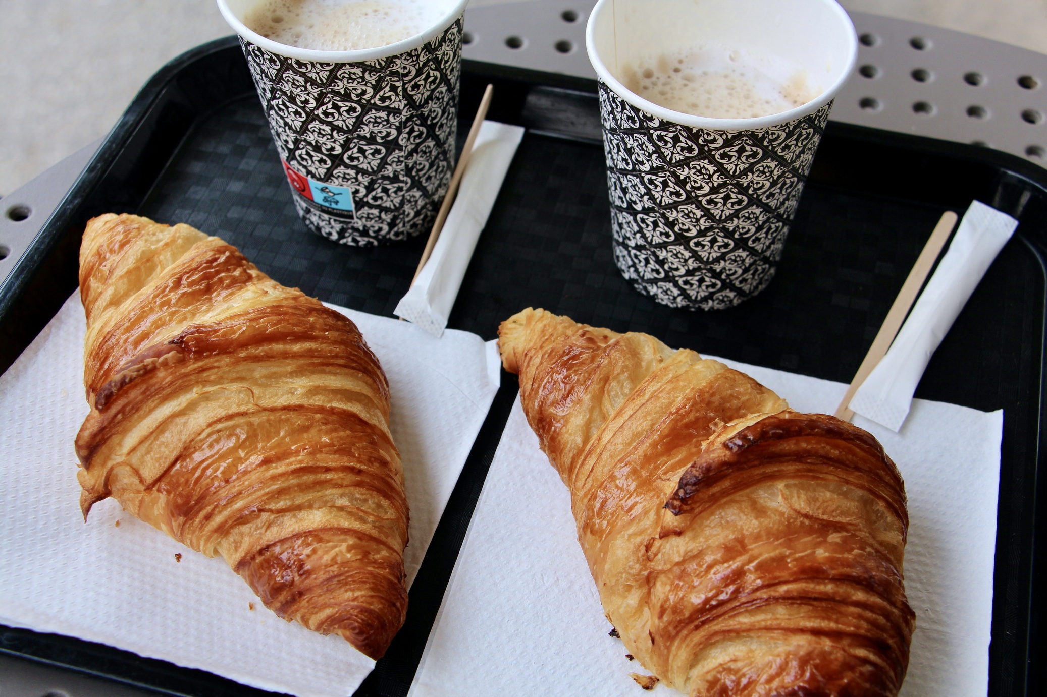 Two croissants and two cappuccinos.