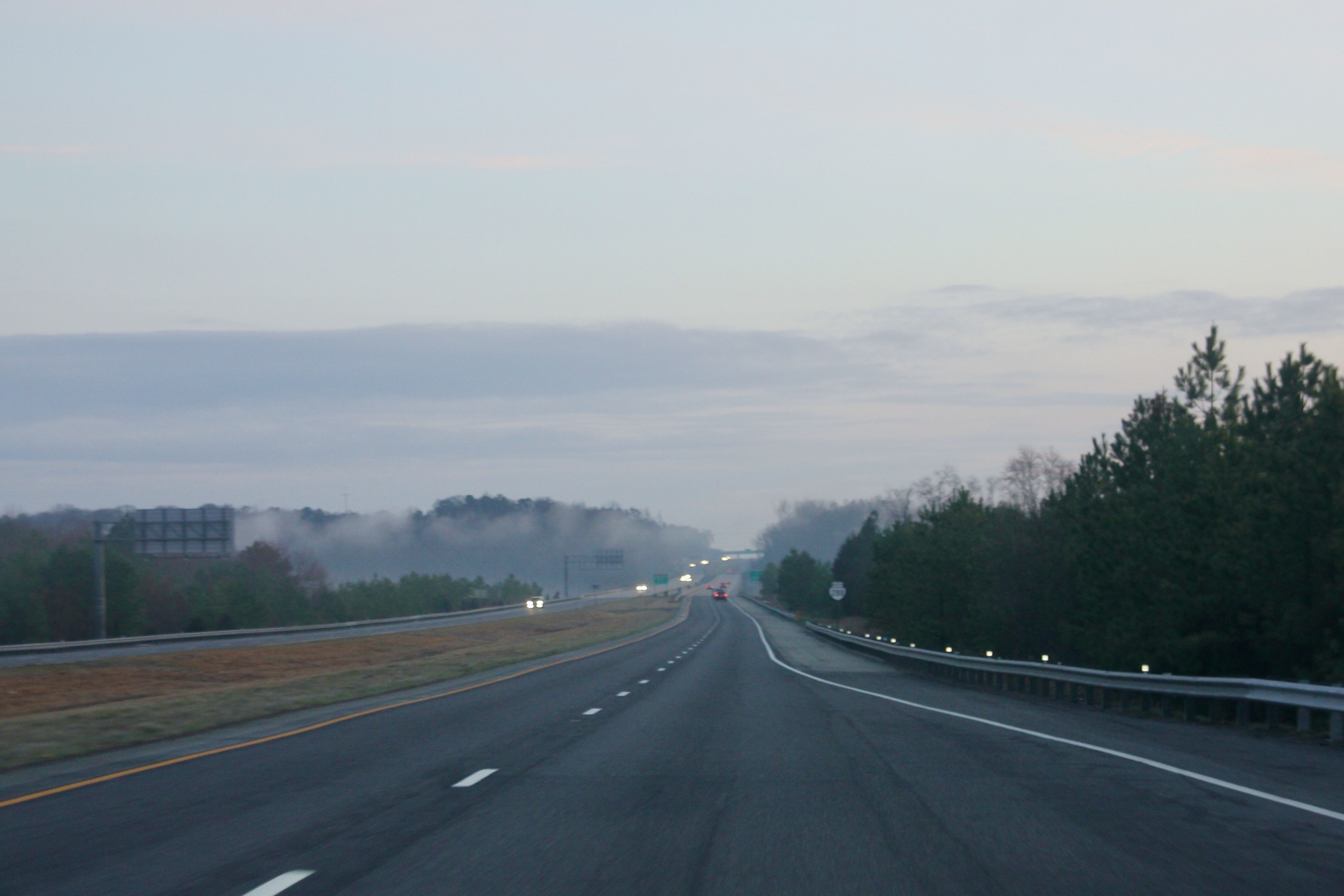 A view of the highway and the light blue and pink morning sky in Virginia.