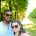 Jalen and Maria pose among the trees on the grounds of the Palace of Versailles.