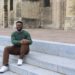 Jalen sitting on the steps of the Basilique Saint-Remi in Reims, France.