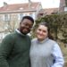 Jalen and Maria stand together and smile in the Parc Saint-Remi in Reims, France.