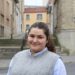 Maria smiles in front of the Rue des Martyrs in Reims, France.