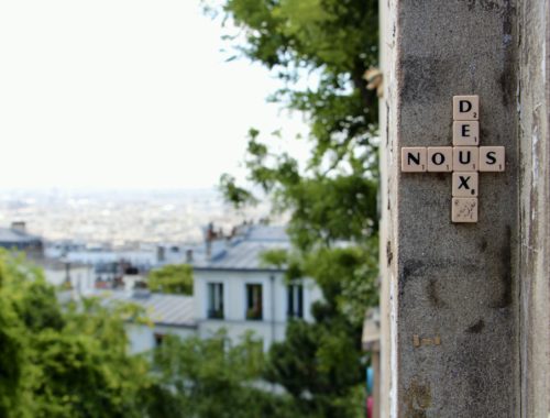 Scrabble street art that spells "nous deux" in Montmartre, Paris, France.